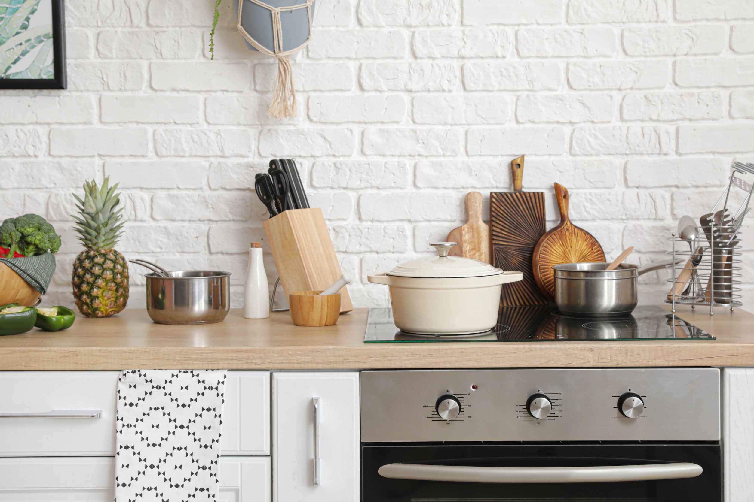 Modern electric stove and utensils in kitchen Modern electric stove and utensils in kitchen