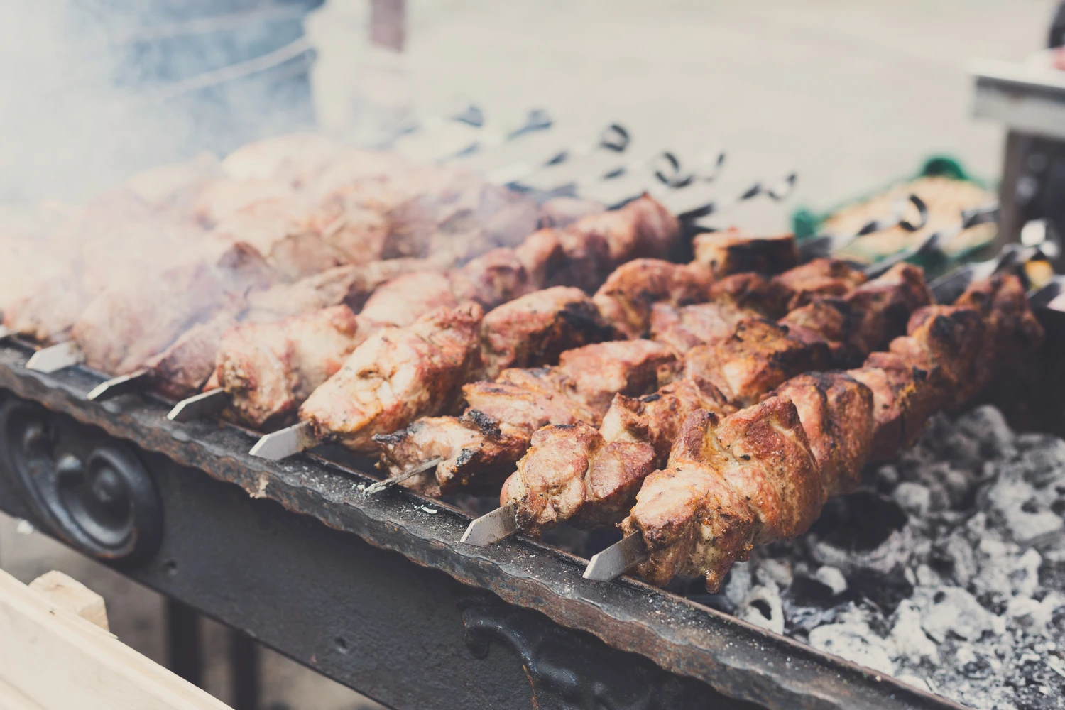 78203627_m (1) Grilled kebab cooking on metal skewer closeup. Roasted meat cooked at barbecue. BBQ fresh beef meat chop slices. Traditional eastern dish<br />