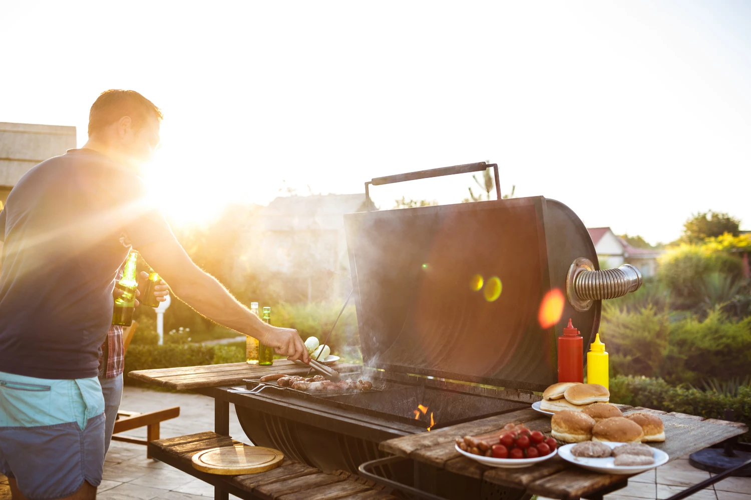 83774132_m (1) Young handsome men roasting barbecue on grill in cottage countryside. Copy space.